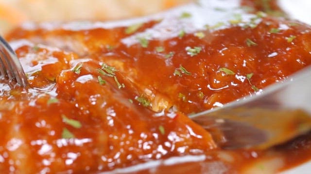 Cheese-filled pork cutlet being sliced