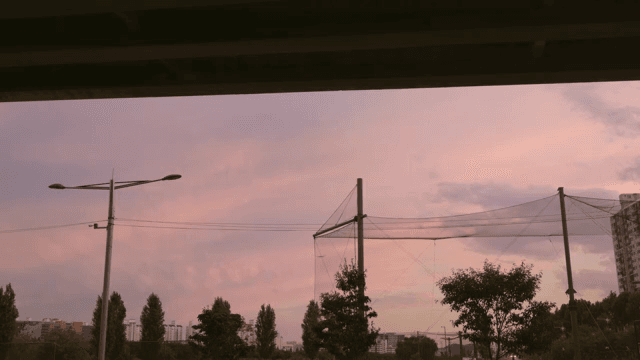 Pink sky dyed in sunset seen from under the bridge