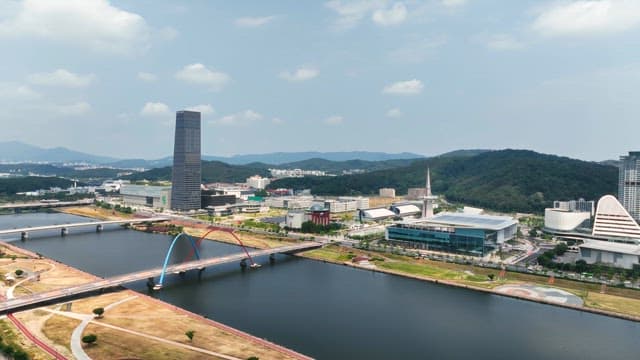 Modern cityscape with a river and bridge