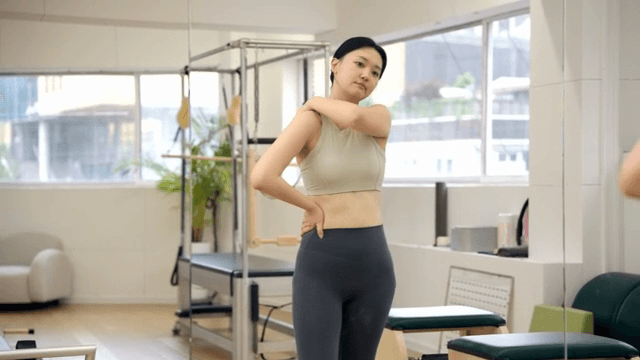 Woman preparing in the mirror at the pilates center