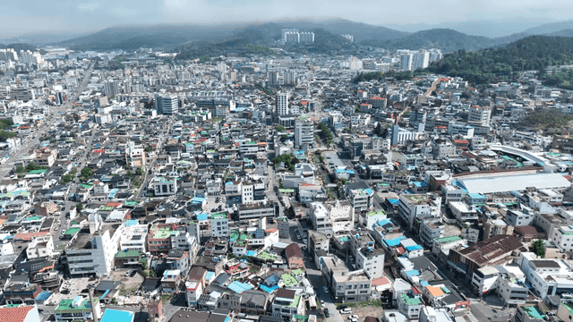Sprawling cityscape with distant hills