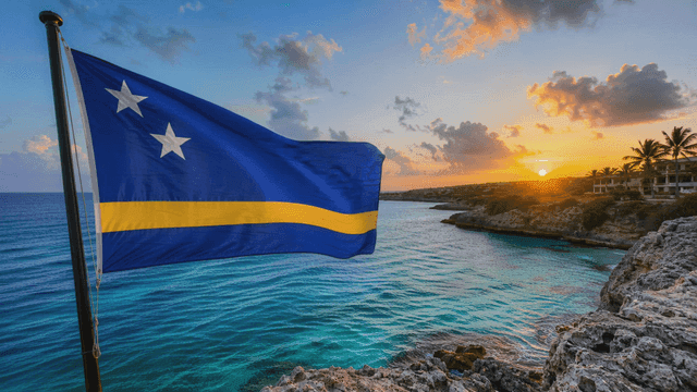 Curacao flag fluttering by sea at sunset