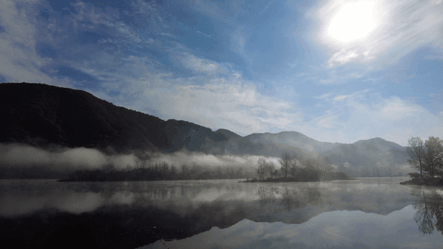 Misty mountains and tranquil lake