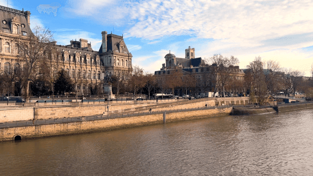 Historic European buildings lined up along riverbank