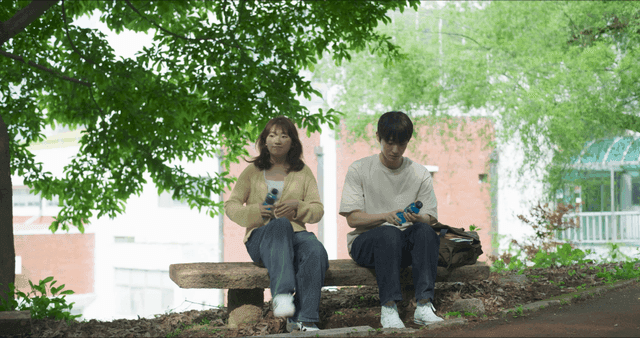 Two people having a conversation on a bench