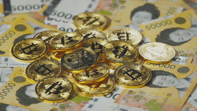 Bitcoin coins on Korean won bills