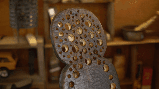 Wooden sculpture with circular carvings