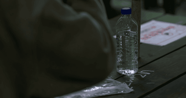 Water bottle and plastic bag on table