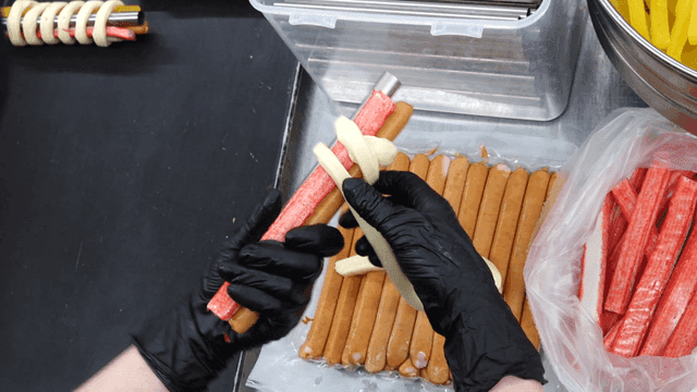 Bread dough wrapping kimbap ingredients and metal rod