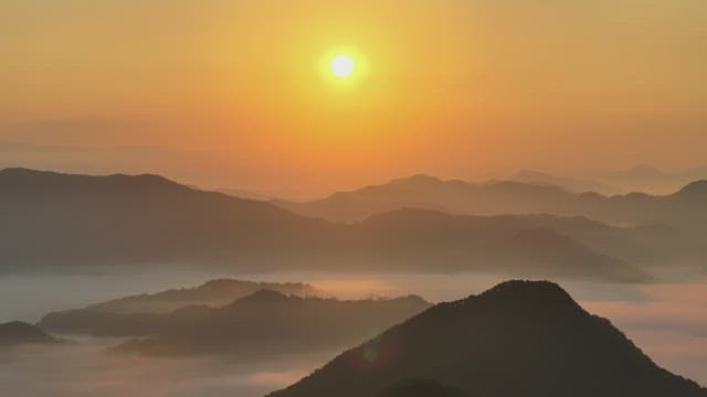 Majestic Sunrise Over Misty Mountains