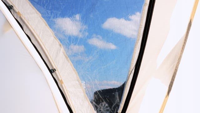 Blue and clear sky reflected in the tent window