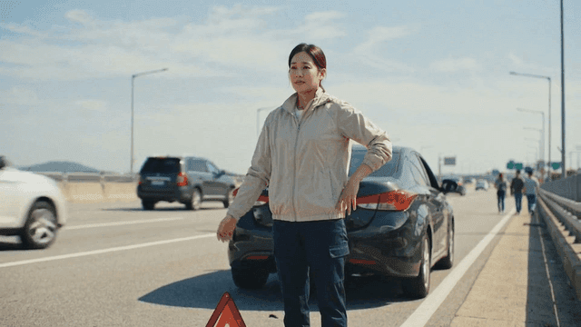 Woman setting up tripod on highway