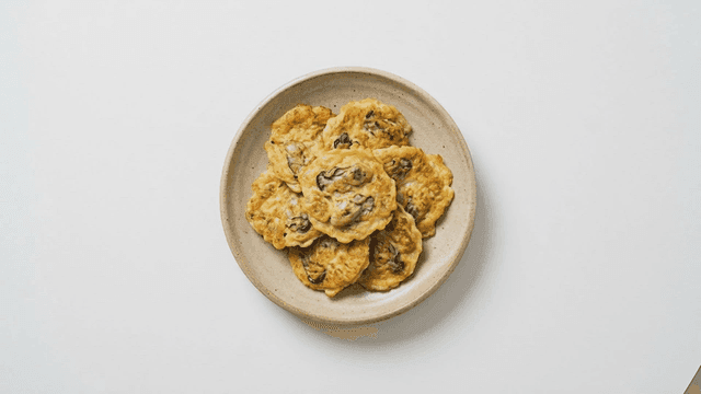 Plate of oyster pancakes on white background