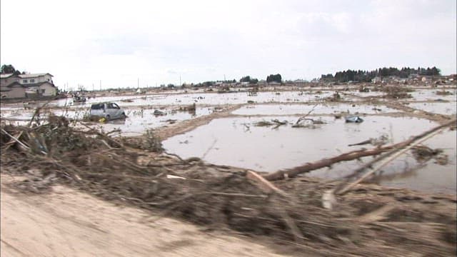 Aftermath of a tsunami with debris and a car