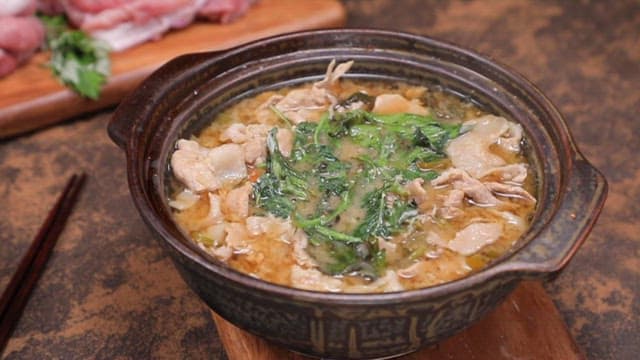 Spoonful of rice with pork soup in a pot