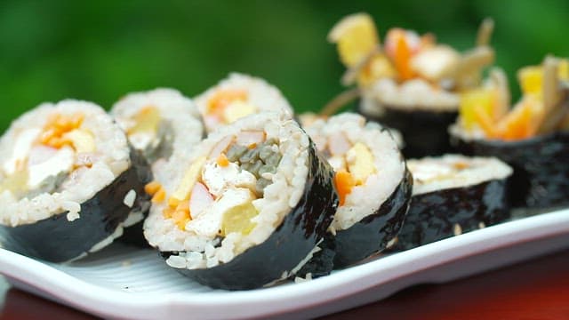 Gimbap neatly plated on a white plate