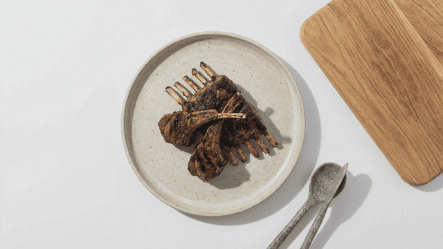 Grilled lamb chops on a ceramic plate