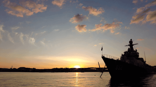 Boat on calm river at sunset.