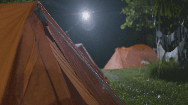 Camping tents illuminated by bright lights