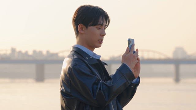 Man taking photos by the riverside