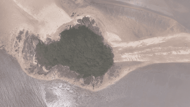 Aerial view of a small island with sandy shores