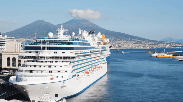 Cruise ships docked with mountain backdrop