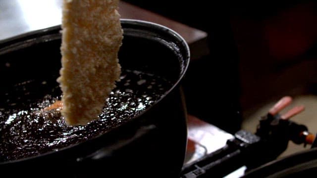 Breaded cutlet frying in hot oil