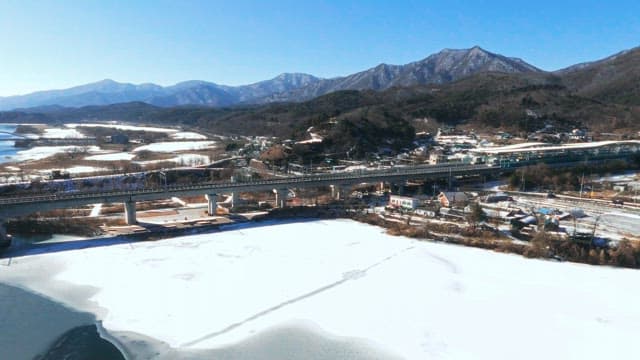 Winter Landscape with Rails and Frozen River