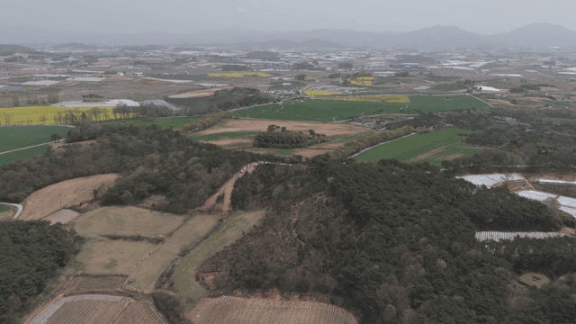 Wide farmland and green fields.