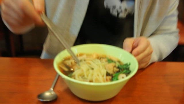 Bowl of udon with spicy sauce and fish cake