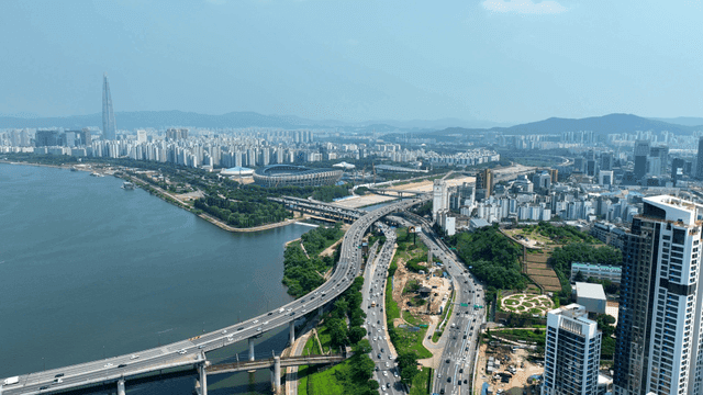 Bustling city with river and highway