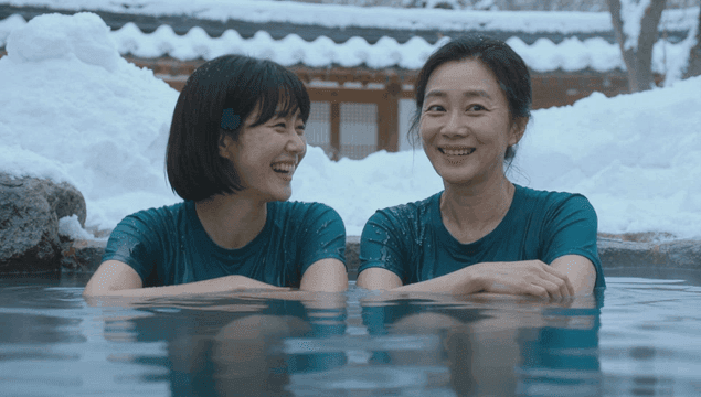Mother and daughter enjoying a winter hot spring