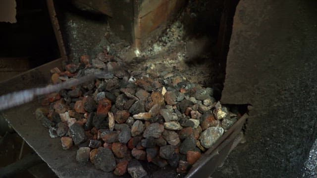 Coal being shoveled in a furnace