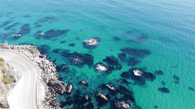 Coastal road alongside a clear blue sea