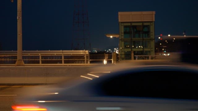 Nighttime bridge with passing cars