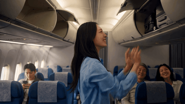 Passengers storing luggage in airplane cabin