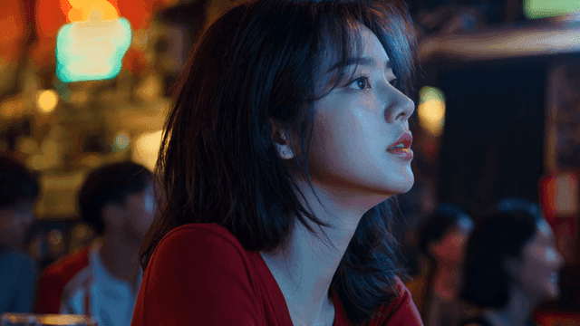 Woman alone in pub amidst excited people