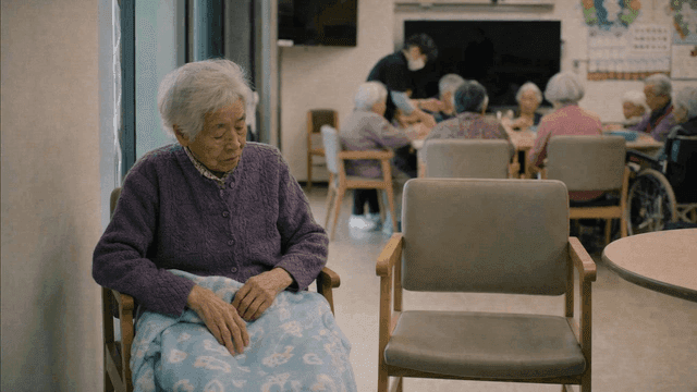 Elderly woman sitting alone in nursing home