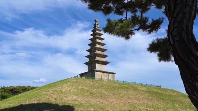 Traditional Stone Pagoda on a Grassy Hill