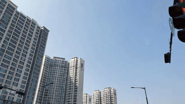 Tall buildings and traffic lights under a clear sky