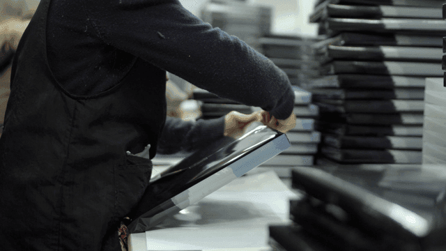 Person packaging products in a factory