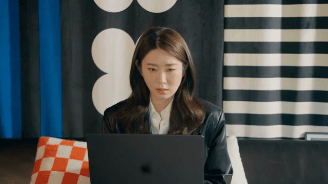 Woman focused on her laptop indoors