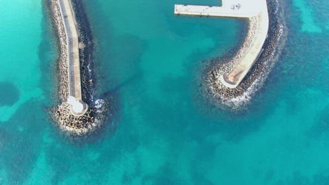 View of a coastal pier and clear sea