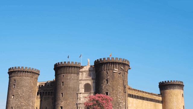 Historic castle with flags and blue sky