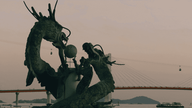 Dragon statue with a bridge in the background