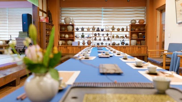 전통적으로 꾸며진 방에서 다기로 아름답게 차려진 긴 테이블