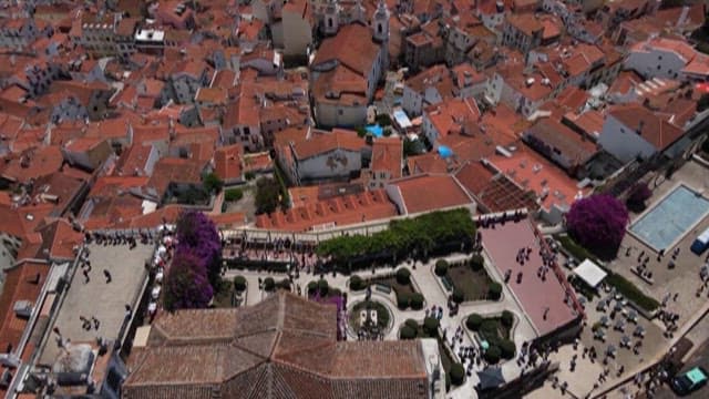 Top View of a Bustling European Town with Red Rooftops and Small Town Square