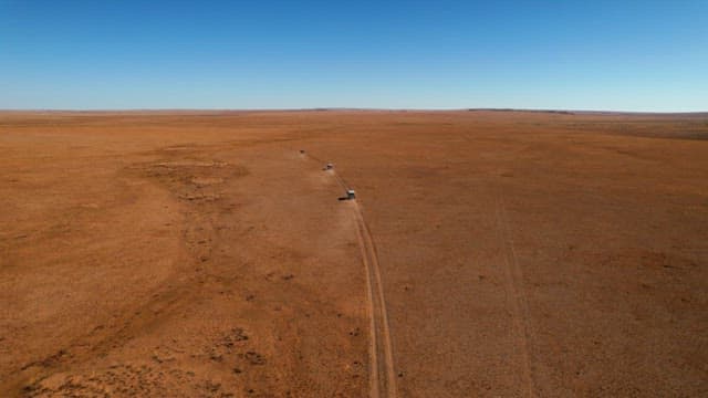 Vehicles traversing a remote arid landscape