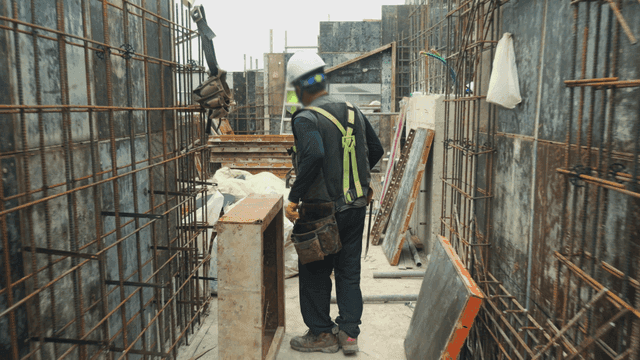 Worker using a hammer on a construction site