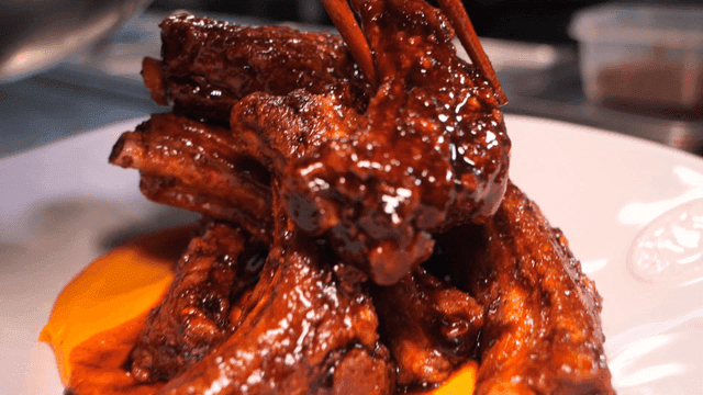 Glazed marinated ribs piled on plate